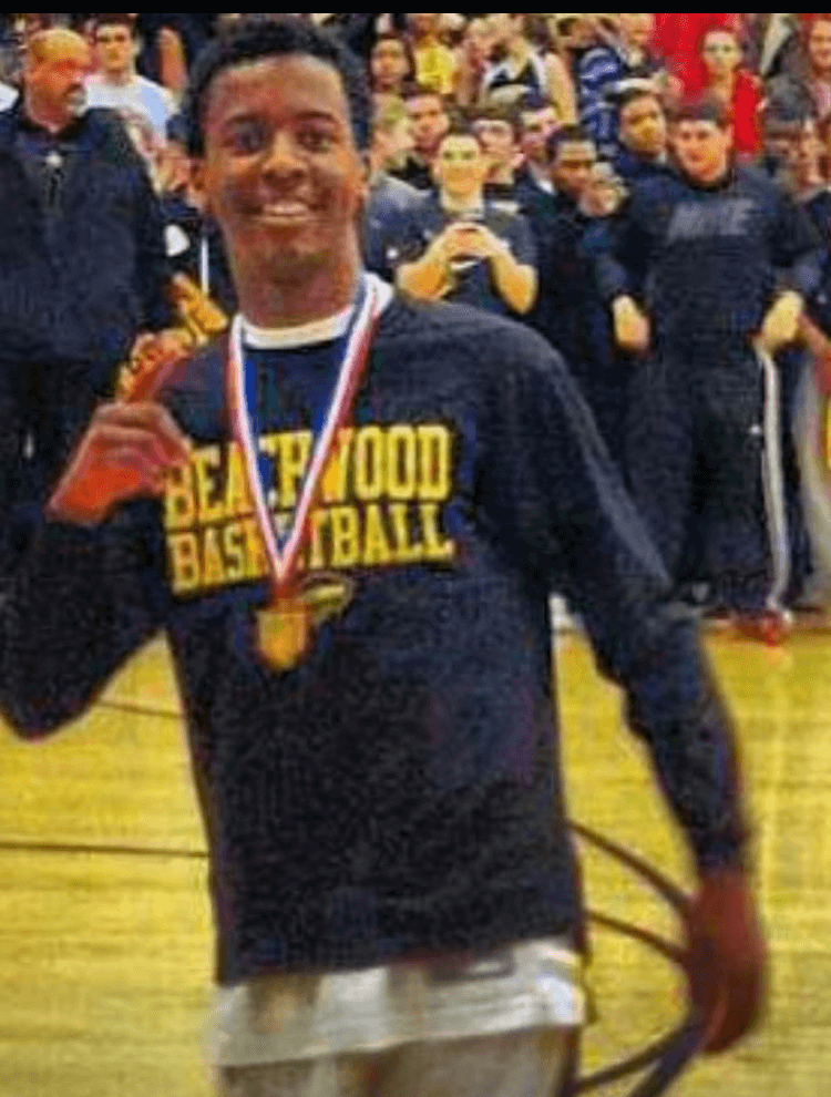 A boy wearing a medal and smiling